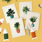 HeyHobby Tranquil Plants punch needle DIY kit with four colorful plant designs on fabric, perfect for crafting and home decor.