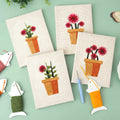 HeyHobby Floral Serenity punch needle DIY kit with colorful floral design and four punch needle tools on a neutral background.