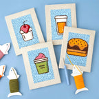 HeyHobby Foodie Fiesta 4-Piece Punch Needle DIY Kit with colorful fabric and tools for creating punch needle art projects.