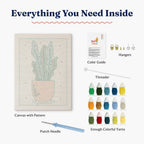 Inside view of HeyHobby Tranquil Leaf Punch Needle Kit with colorful yarns and tools for DIY embroidery craft.