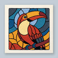 Punch needle wall art kit featuring a stained glass style toucan in burnt orange, teal blue, and golden yellow
