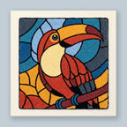 Punch needle wall art kit featuring a stained glass style toucan in burnt orange, teal blue, and golden yellow