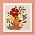 Punch needle wall art of a woman's profile with a red flower crown, sage branches, and blush tulip buds