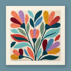 Folk Burst punch needle kit showing a symmetrical botanical fan in teal, coral, mustard yellow, lavender, and burgundy