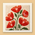 Punch needle kit with five terracotta red and burnt orange poppies on a warm cream canvas, forest green stems
