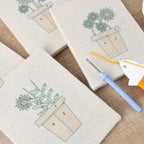 HeyHobby Floral Serenity 4-Piece Punch Needle Set DIY kit with colorful floral designs and tools for embroidery projects.