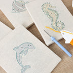 HeyHobby Ocean Friends DIY Punch Needle Set with four colorful, ocean-themed punch needle tools and accessories.