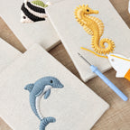 Ocean Friends DIY Punch Needle Set by HeyHobby, 4-piece kit with colorful punch needle tools and yarn for crafting ocean-themed designs.