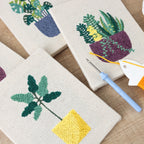 HeyHobby Tranquil Greens punch needle DIY kit with four colorful punch needle tools and accessories, ideal for craft projects.