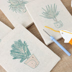 HeyHobby Tranquil Plants 4-Piece Punch Needle Set DIY kit with colorful fabric and tools for creating plant-themed punch needle art.